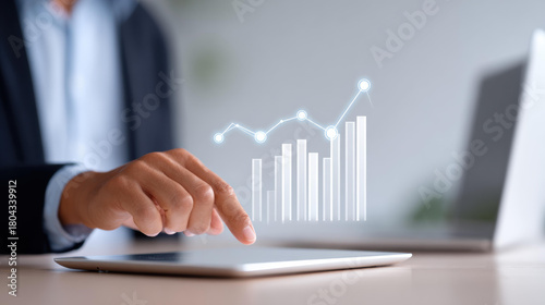 Focused businessman doing financial analysis on digital tablet. virtual chart shows business growth, data, and investment success with futuristic technology