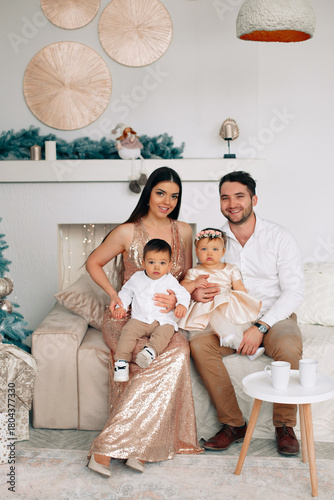 Family celebrates special occasion in elegantly decorated living room with festive decor and cozy seating, capturing joyful moment together