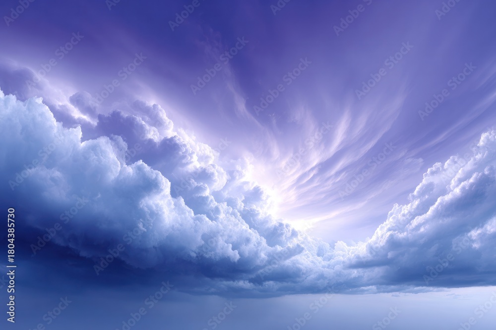 Obraz premium Celestial Symphony: A breathtaking display of swirling, billowing clouds in shades of purple and blue, filling the frame with a sense of awe and wonder.