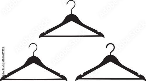 Three black clothing hangers in silhouette