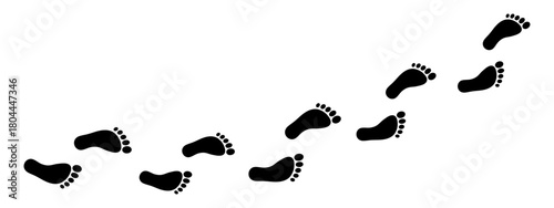 Minimalist trail of human footprints. Silhouettes of bare feet form a winding path of footsteps