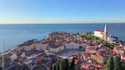 Aerial view of Piran with St. George Church and snowy Alps on background. Beautiful Coastal City in Slovenia