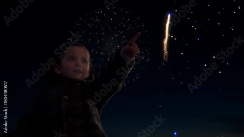 Amazed little girl watching fireworks display