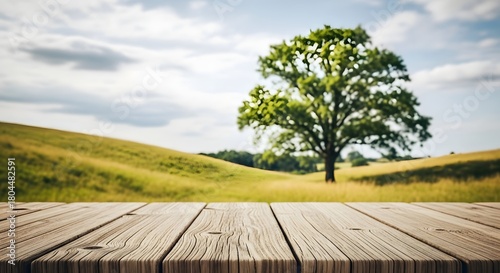 Fototapeta Naklejka Na Ścianę i Meble -  Rustic wooden table in a lush green rolling countryside landscape