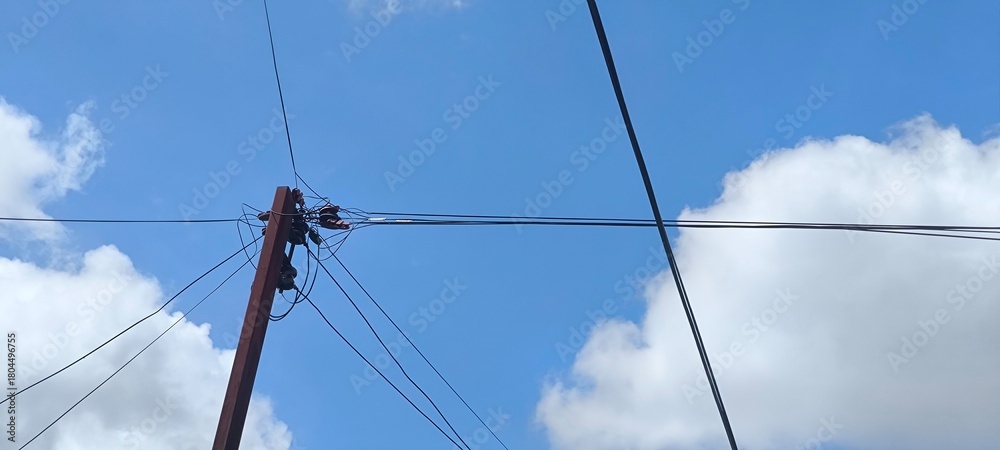 Fototapeta premium Electric poles and blue sky
