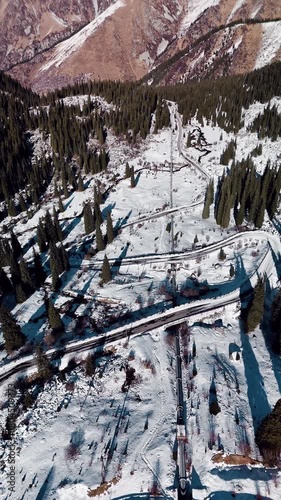 Aerial view of mountain lake at winter with snow