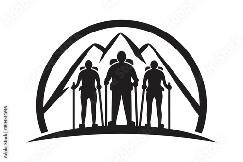 Three hikers with trekking poles stand before majestic mountain peaks in monochrome silhouette