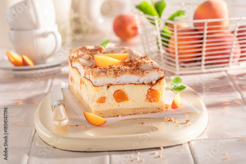 Delicious and tasty peach cheesecake with fruits, meringue and foam.
