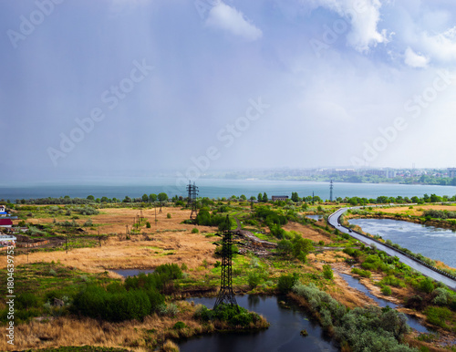 Heavy rainfall over countryside near lake