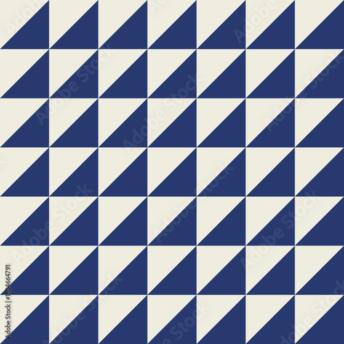 Seamless geometric pattern with diagonally into a dark blue triangle and an off-white triangle.