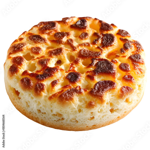 A single golden brown crumpet with a porous textured top sits on a clean white background