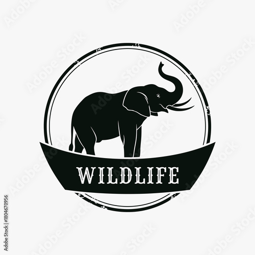 Powerful elephant silhouette in a circular wildlife emblem.