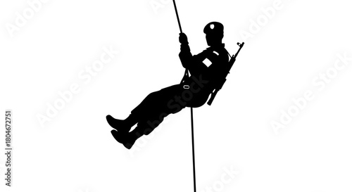 Silhouette of a person rappelling down a rope, wearing a helmet and gear.