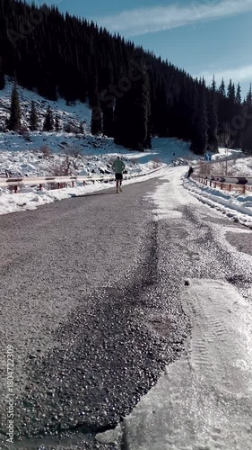 Man running at the road in the mountains