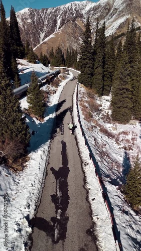 Man running at the road in the mountains