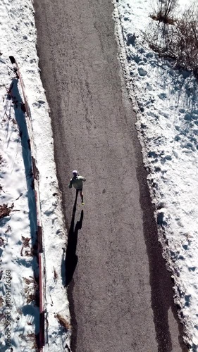 Man running at the road in the mountains