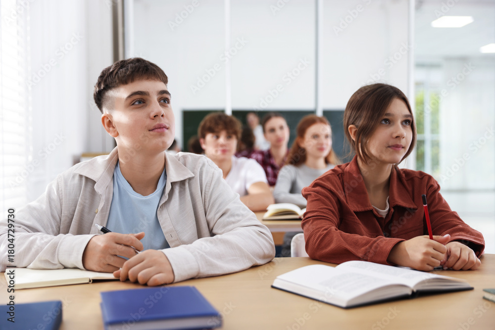 Fototapeta premium Teacher and students during lesson in classroom, selective focus