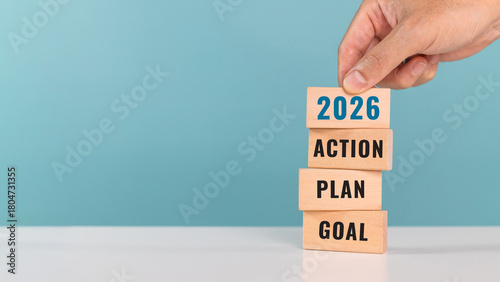 2026 GOAL PLAN ACTION. start up business. new year. Put last piece of wooden cube with the letters 2026. Steps required to achieve the goal
