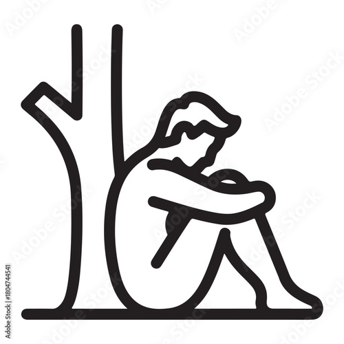 Man sitting under a tree hugging his knees in sadness hugging knees