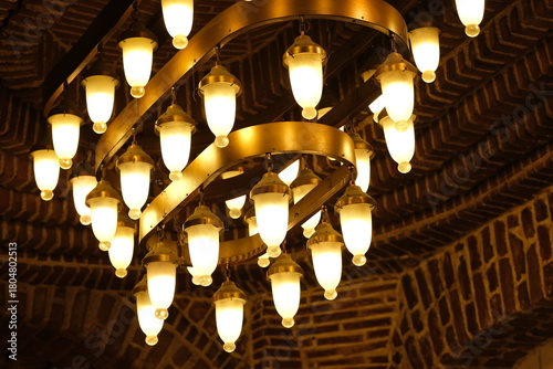 Retro style electric chandeliers in interior of a brick structure at Istanbul