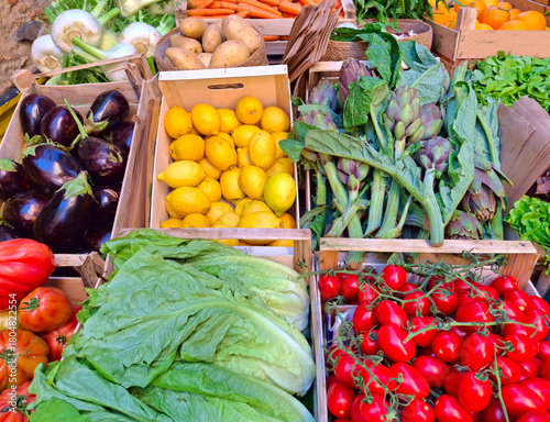 display of colorful vegetable boxes at the market