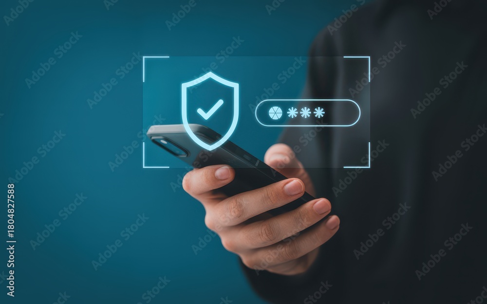Obraz premium Person using a smartphone with a holographic display showing a security shield and password entry for online data protection and privacy