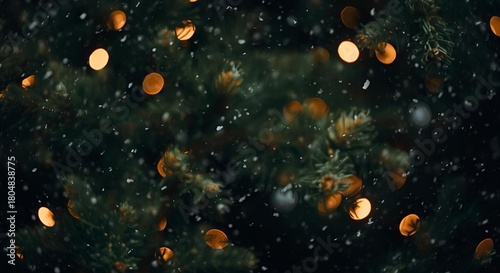 A close up of a christmas tree with lights and snow falling in a dark and festive scene