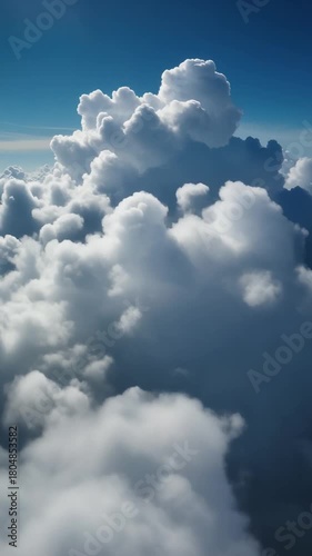 Forward drone push toward bright fair-weather cumulus