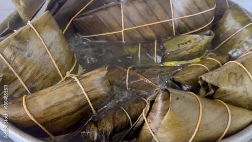 Traditional Latin American Hallacas Wrapped in Plantain Leaves Boiling in a Pot for Christmas Dinner