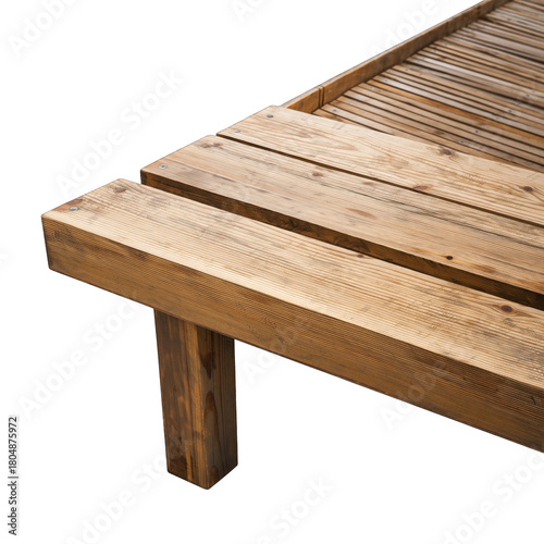 Weathered wooden deck planks in sharp focus against a dark background highlighting the textured wood grain and natural brown tones of outdoor furniture