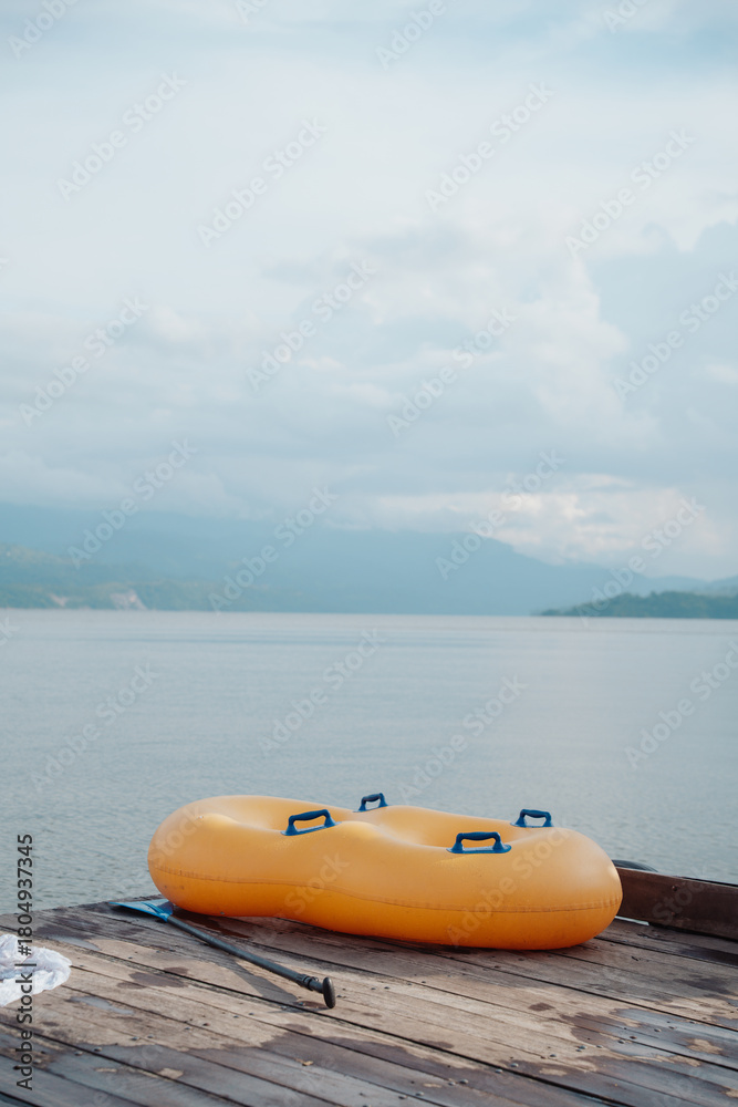 Fototapeta premium double inflatable float on a dock on a beautiful lake surrounded by mountains