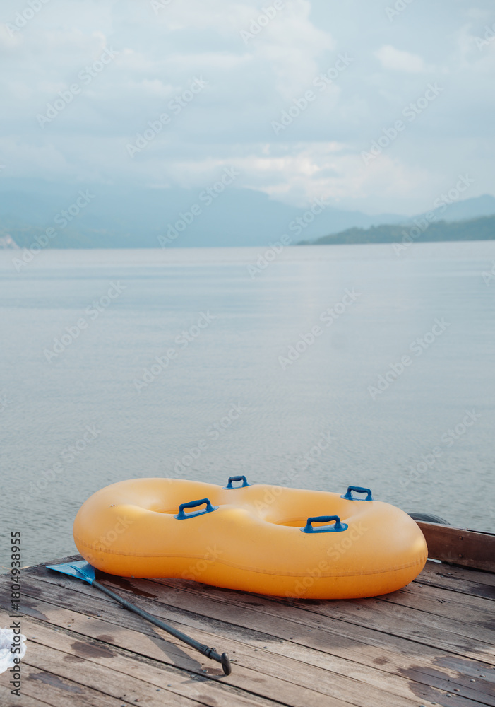 Fototapeta premium double inflatable float on a dock on a beautiful lake surrounded by mountains