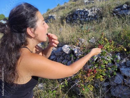 Woman Eating Fresh Wild Blackberries Outdoors