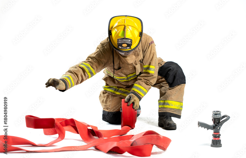 Naklejka premium Portrait of a firefighter in protective uniform holding a firefighting and fire hose nozzle