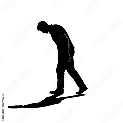 Silhouette of lonely man walking with head down on white background with copy space