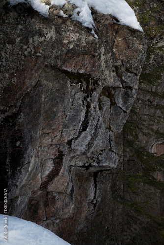 Rock formations on the shores of a frozen lake in winter in Finland
