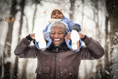 father and child boy in winter forest with parents and kids love relationship having warm clothes for cold climate