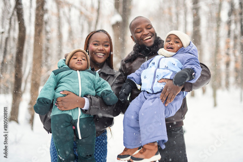 family in winter forest with parents and kids love relationship having warm clothes for cold climate