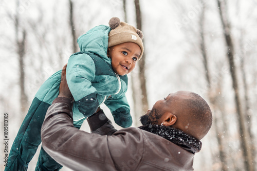 father and baby in winter forest with parents and kids love relationship having warm clothes for cold climate