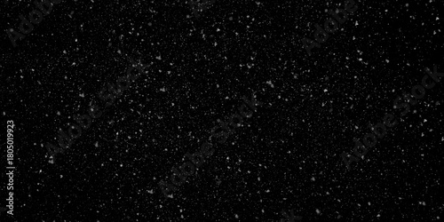 Snow texture overlay with very small, blurred white particles falling against an isolated dark black background horizontally