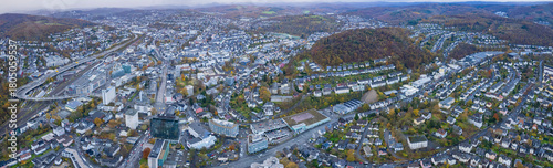An aerial panorama view above the old town of the city Siegen on an early summer morning in Germany