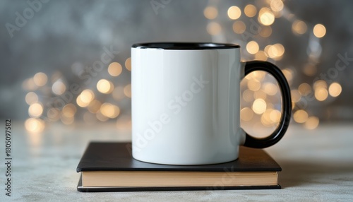 Black Handle Mug Displayed On A Book Surrounded By White Bokeh Lights In A Mock-Up Photo Of An 11 Oz White Ceramic Mug.