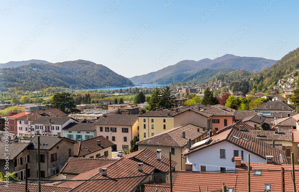 Obraz premium Panoramic view from the village of Bioggio overlooking Lake Lugano and the surrounding mountains in the canton of Ticino, Switzerland.