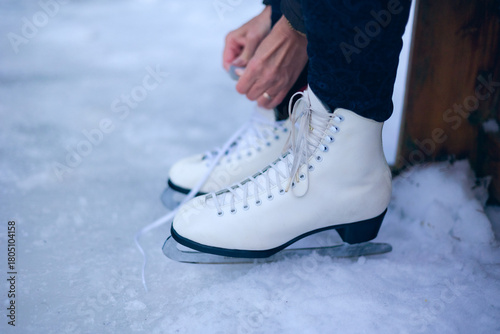 Lacing up ice skates outdoors
