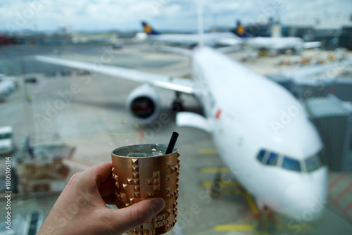 Frankfurt, Germany, June 10, 2019: Moscow Mule Cocktail with View of Long Haul Aircraft at the Gate