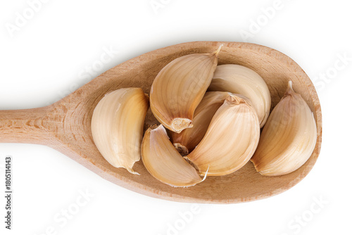 garlic cloves in wooden spoon isolated on white background close up. Top view. Flat lay.