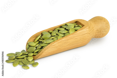Peeled pumpkin seeds in wooden scoop isolated on white background