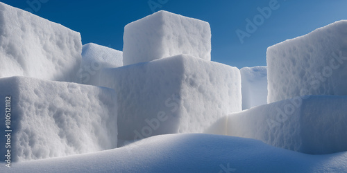 Blocks of snow piled under blue sky in winter landscape  