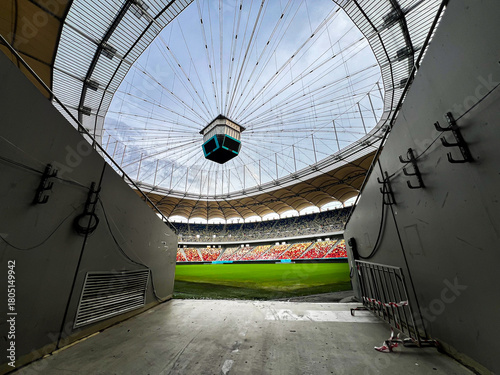 Massive Soccer Stadium tunnel.View of empty stadium. Green grass on a sport Arena. Empty Football Soccer Stadium Tribune. National arena with empty seats. Sport event on National Arena. 