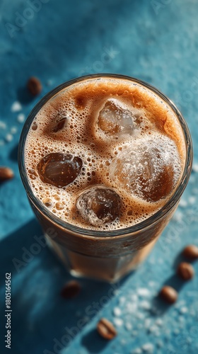 Refreshing Iced Coffee in a Clear Glass With Ice on a Blue Background